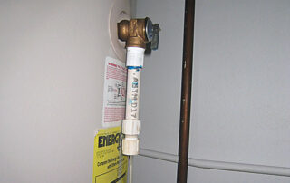 It’s never a good idea to disable a safety valve by capping it. - AMI sample photo of plumbing from a home inspection