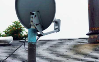 A few things are wrong here. The most obvious is the plumbing vent pipe that supports a satellite dish. Our plumbing code calls this “flagpoling” and prohibits it outright - sample photo from a home inspection