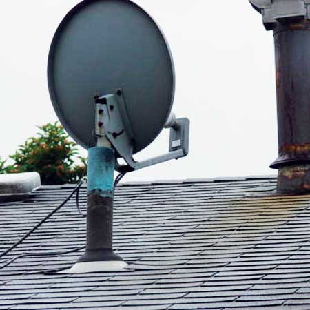 A few things are wrong here The most obvious is the plumbing vent pipe that supports a satellite dish Our plumbing code calls this flagpoling and prohibits it outright